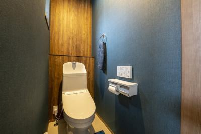 トイレ：2階のトイレは両サイドにネイビーのクロスを、正面はアクセントに木目調のクロスを採用